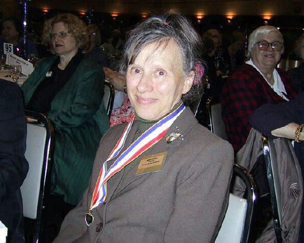 Wendy wearing award at table 